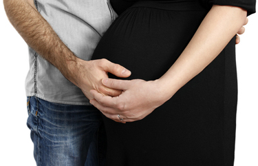 Image of a man ebracing a pregnant woman